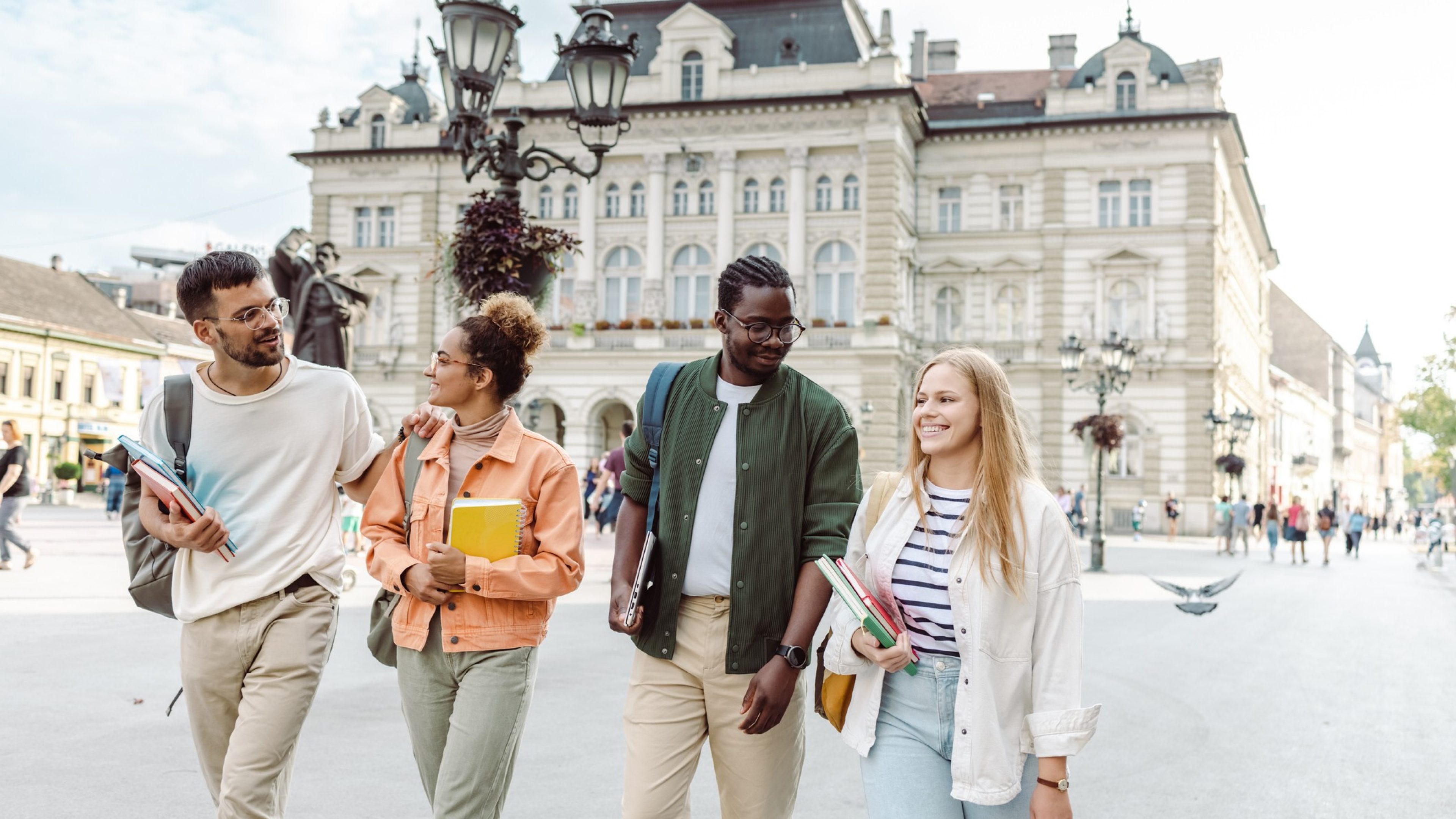 A Group of University students cheerfully walking on the street and laughing